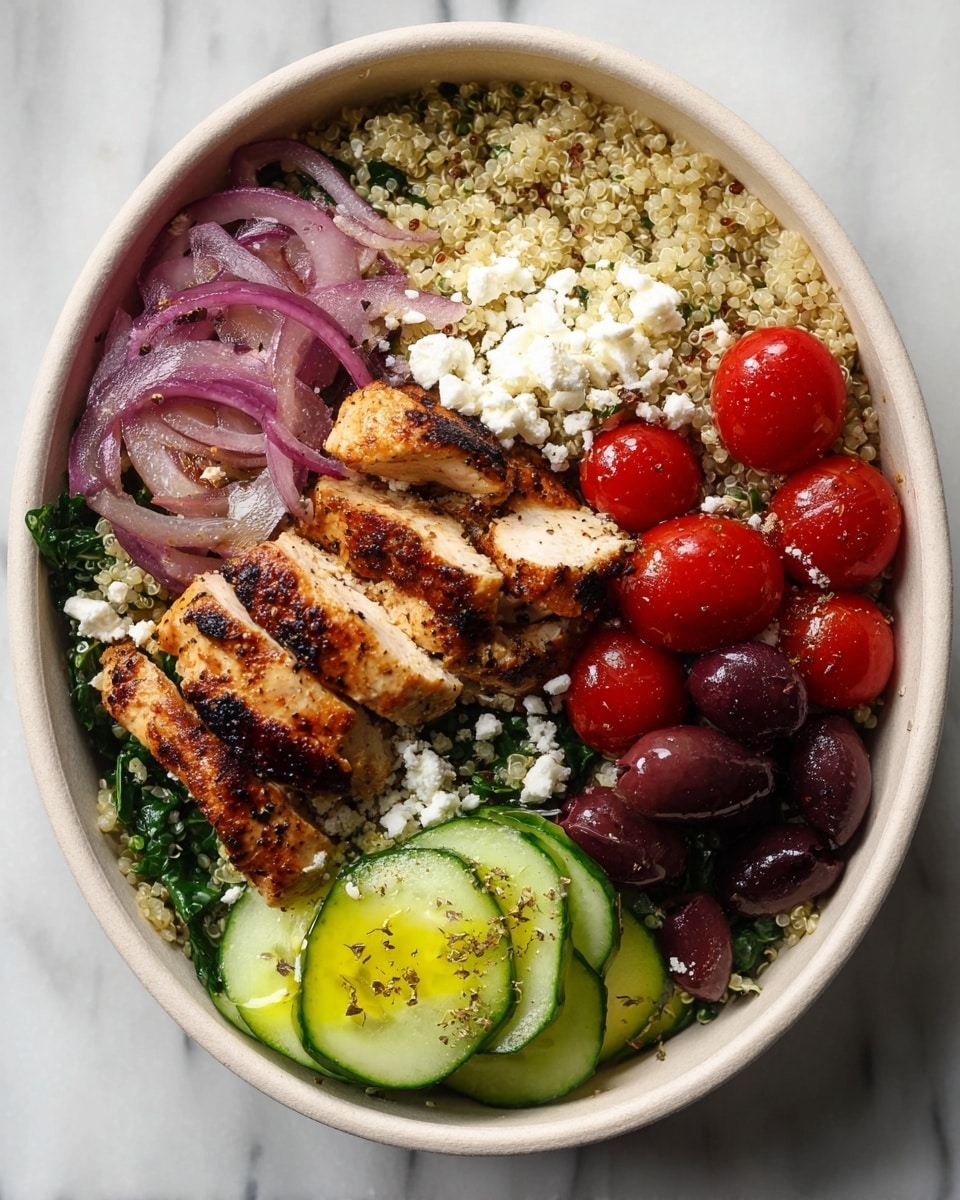 This dish is served in a white bowl with a curved edge, placed on a white marbled surface. The base layer is light beige quinoa mixed with green spinach, filling about half of the bowl. On top of the quinoa near the center, there are 5 pieces of grilled chicken breast, golden brown with charred marks. To the left side, there are thin purple-red slices of onion topped with scattered white crumbled feta cheese. Below the onions, a cluster of bright red cherry tomatoes sits, some glistening with seasoning and also sprinkled with feta. On the right side, there is a small pile of dark purple black olives, and next to them, several thick slices of fresh green cucumber with a drizzle of yellow olive oil and pepper. The textures range from soft quinoa and chicken to crunchy onions and creamy feta. photo taken with an iphone --ar 4:5 --v 7