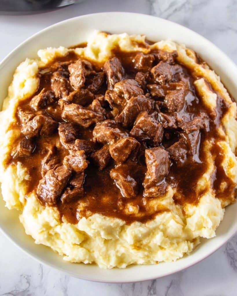 Beef Tips in Rich Gravy Served Over Mashed Potatoes Recipe