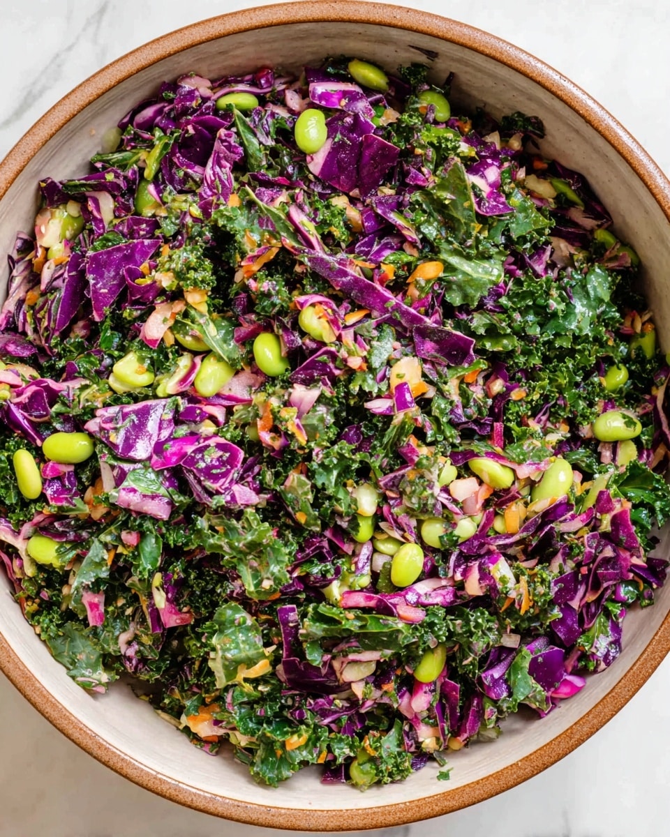 A large white bowl with a brown rim is filled with a colorful mixed salad made of finely chopped dark green kale, bright green lima beans, and small pieces of purple cabbage, with hints of light green herbs and tiny orange bits scattered throughout. The salad has a fresh, crunchy texture with layers of leafy greens interspersed with legume shapes and crunchy vegetables, all evenly mixed and filling the bowl to the top. The bowl sits on a white marbled textured surface. photo taken with an iphone --ar 4:5 --v 7